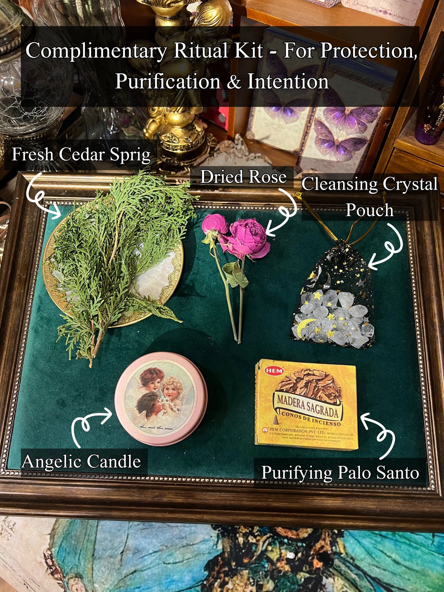 Complimentary ritual kit for spiritual protection, featuring cedar sprig, dried rose, crystal pouch, angelic candle, and Palo Santo incense, displayed on a velvet tray.